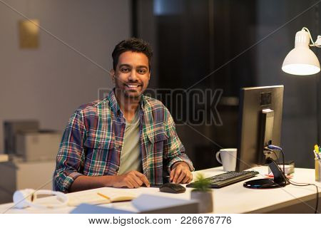 deadline, technology and people concept - happy creative man with tablet pc computer working at night office