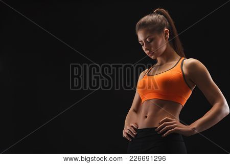 Athletic Woman, Bodybuilder, Muscular Body. Studio Shot On Black Background, Low Key. Bodybuilding C