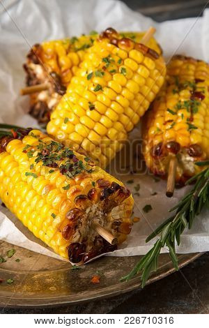 Corn Grilled With Salt And Spices. Dark Background. Fast Food In The Summer