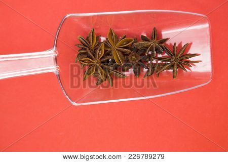 Glass Spoons With Dry Spices And Fresh Herbs On A Rose Background, Top View, Close Up