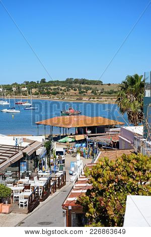 Alvor, Portugal - June 7, 2017 - Restaurant Lined Street With Views Towards The Fish Market And Estu