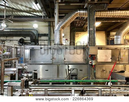 LONDON - FEBRUARY 12, 2018: Automatic kegging equipment robotic machinery production line for filling metal kegs with beer at Fullerâs Brewery in Chiswick, West London, UK.
