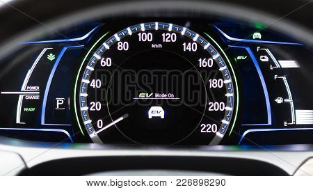 Ev- Electrical Vehicle Mode Turned On On Hybrid Car Screen In Front Of Steering Wheel For Green Powe