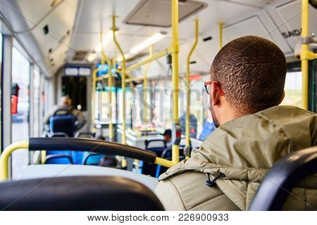 Lisbon, Portugal - January, 2018. African American Man Is Sitting On The Bus And Looking Out The Win