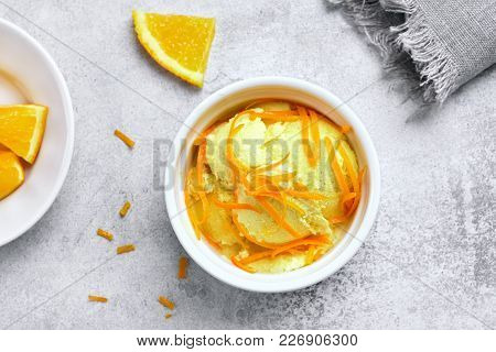 Tasty Orange Ice Cream In Bowl On Stone Background. Cold Summer Dessert. Fruit Sorbet. Top View, Fla