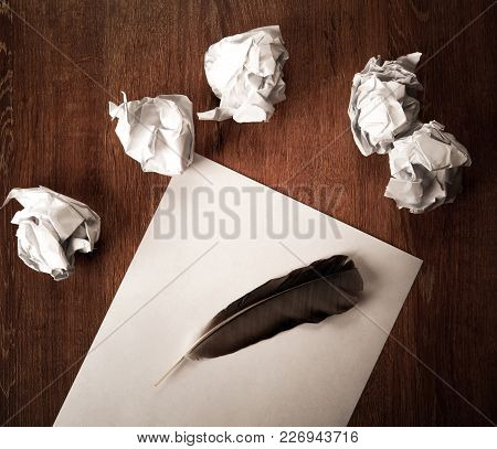 Still Life Of Paper And A Crumpled Paper On A Table With A Pen On A Wooden Table