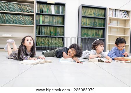 Happy Kids And Bored Kids Reading On The Floor, Education Lifestlye In The Library. Young People Exp
