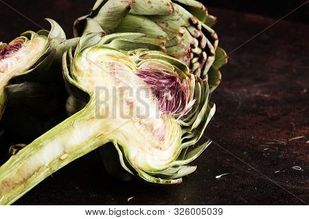 Artichokes On Rustic Dark Background. Fresh Organic Artichoke Flower.