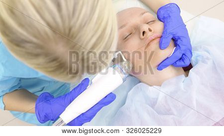 Microneedle Rf Lifting Procedure. Hardware Cosmetology. Beautician Conducts A Facial Rejuvenation Pr