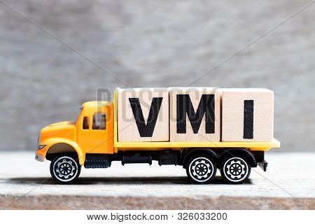 Truck Hold Letter Block In Word Vmi (abbreviation Of Vendor Managed Inventory) On Wood Background