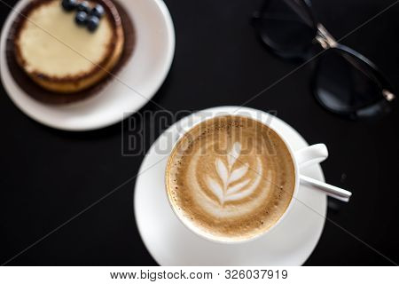 Breakfast With Cappucino And Cake With Bluebarries In Cafe