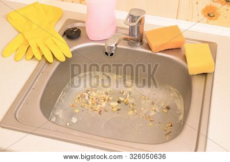 Close Up On Dirty Clogging Kitchen Sink Drain With Food Particles