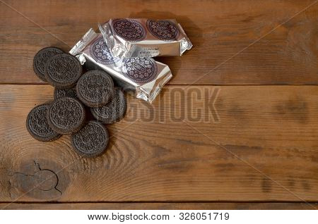 Oreo Sandwich Cream Biscuits Mini Packs And Cookies On Dark Wooden Background