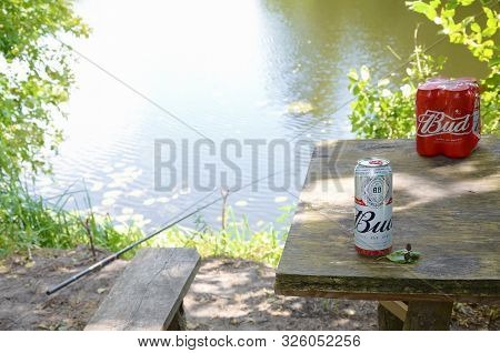 Sumy, Ukraine - August 10, 2019: Budweiser Bud Beer Can On Old Wooden Table Outdoors At The River An