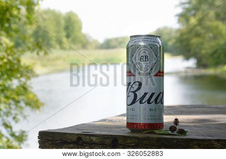 Sumy, Ukraine - August 10, 2019: Budweiser Bud Beer Can On Old Wooden Table Outdoors At The River An