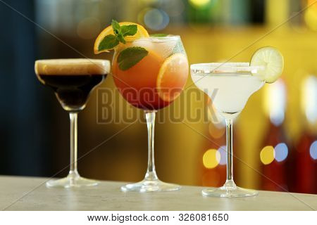 Row Of Different Fresh Alcoholic Cocktails On Bar Counter