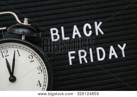 White Text Black Friday On Black Letter Board And Alarm Clock, Closeup. Concept Black Friday , Seaso