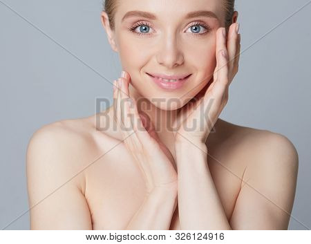 Portrait Of Beautiful Woman With Natural Make Up Touching Her Face.