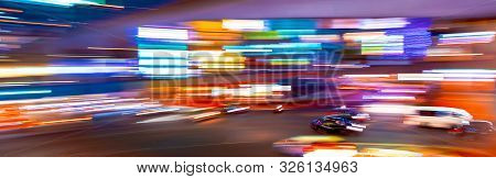 Abstract Blurred View Of People And Traffic Crossing A Busy Intersection In Shibuya, Tokyo, Japan
