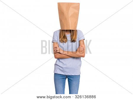 Portrait of teen girl with paper bag over head. Teenager cover head with bag with crossed arms isolated on white background. Child folded hands, pulling paper bag over head.