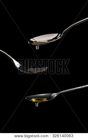 Golden Sweet Honey Dripping From Spoon