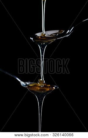 Golden Sweet Honey Dripping From Spoon