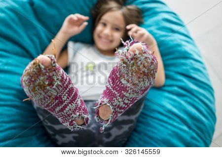 Little cute boy with winter socks open toes