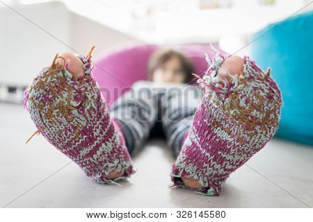 Little cute boy with winter socks open toes