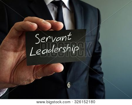 Servant Leadership Concept. Black Piece Of Paper In The Hands.
