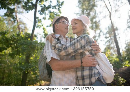 Loving Husband Hugging Wife While Hiking In National Park