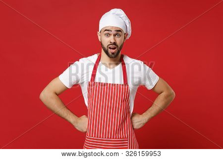Shocked Irritated Young Male Chef Cook Baker Man In Striped Apron White T-shirt Toque Chefs Hat Posi