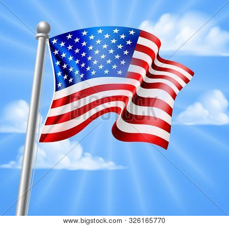 The American Flag On A Flag Pole Flying Against A Blue Sky