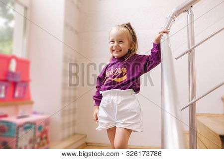 Happy Little Girl Walkning In Toy Store. Cute Girl Choose Toy. Adorable Female In Kids Mall