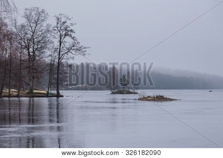 View Of The Ruotsalainen Lake In Winter Scenery. Small, Rocky Islands, Boats Pulled Ashore, Heinola,
