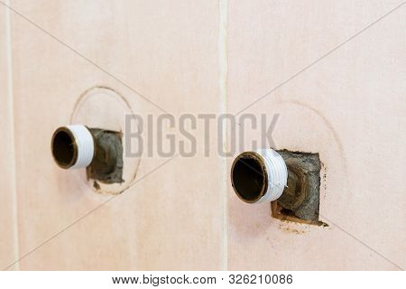 The Plumber Puts Teflon Seam Fum Tape On The Thread Before Installing The Faucet Tap. Close Up