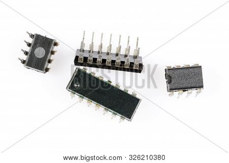 Electronic Components. Four Old Microchips Different Types And Sizes. Macro Studio Shot Of Integrate