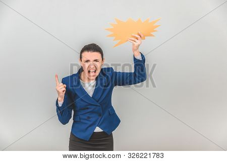 Angry Teacher Raising Up A Sparkle-like Speech Bubble, Threatening Her Finger At The Camera, Yelling