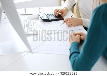 Accountant Checking Financial Statement Or Counting By Calculator Income For Tax Form, Hands Close-u