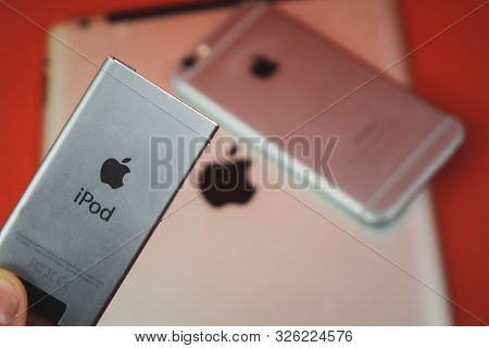 Moscow, Russia - April 25 2019: Ipod, Iphone And Ipad Lying In A Row . Production On Red Background.