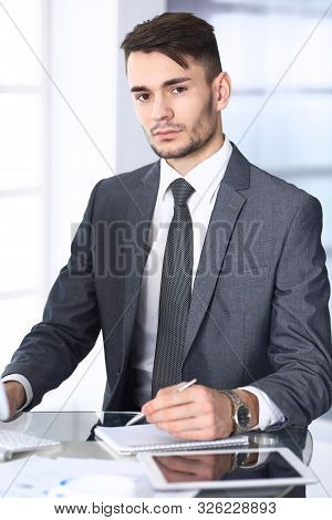 Businessman Working With Computer In Modern Office. Headshot Of Arab Male Entrepreneur Or Manager At