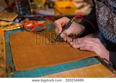 Professional Male Skinner, Tanner Making Decorative Details On Leather Playing Field For Strategy Bo