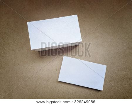 White Shiny Business Cards On A Brown Vintage Surface, Top View. Design Business Card Template, Siri