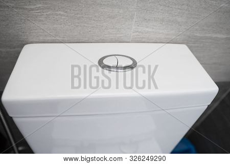 Close Up On A Flush Toilet Button For Cleaning A Toilet.