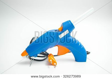 Hot Glue Gun Blue And Orange Close Up And Isolated On White Hand