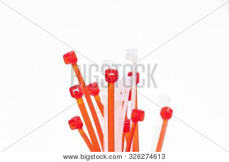 Many Red And White Zip Tie Ties Isolated On White