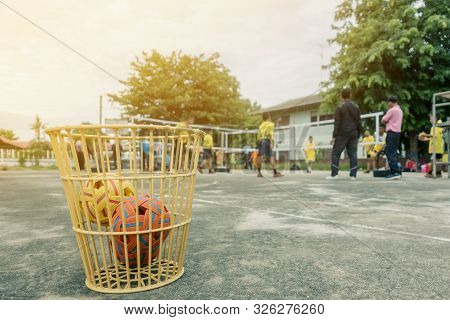 The Takraws In The Plastic Basket On The Cement Floor Beside The Field Is Used For Students To Pract