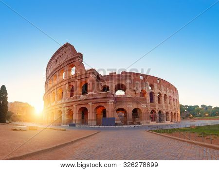 Colosseum (coliseum) In Rome, Italy, On A Sunrise, Panoramic Image With Rising Sun