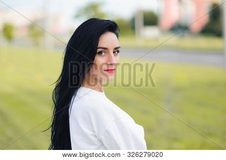 Portrait Of A Beautiful Athletic Girl. Beauty And Health Concept. Brunette In White Maik And Black R