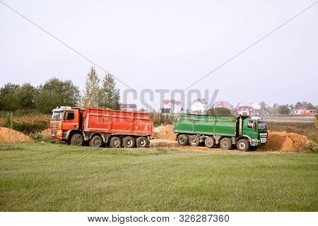 Two Large 70-ton Dump Trucks Brought Sand To The Site To Add To The New Construction Site
