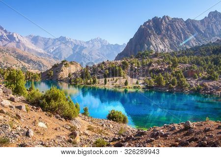 Scenic Mountains Landscape With Blue Lake On Sunny Day. Beautiful View On Turquoise Water On Mountai
